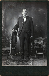 Man in Bowtie with Chair and Table