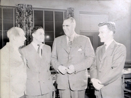 Faculty: Four Men Standing Talking