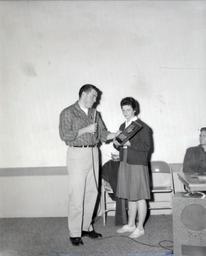 APO Ugly Man Contest--Winner: Stan Albeck, Students: Ray Clemo and Jay Holman 1961: Man Speaking After Being Awarded Plaque