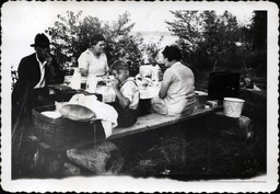 Young Tom Ross and Family at Picnic Table