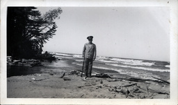 Tom Ross on Beach with Shotgun