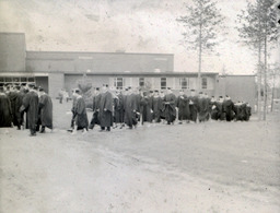 Commencement 1960: View of Graduates Walking in Line Outside