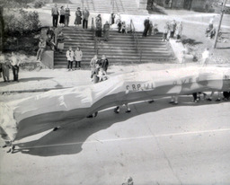 Events--Homecoming: People Standing on Steps Watching Students Walk Under Homecoming Float Thing