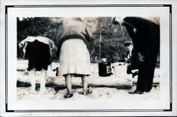 Women Leaning over Driftwood