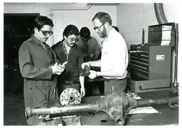 Three Men Looking at Car Parts (Part of the NMU Historic Photographs Collection)