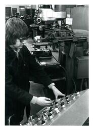 Student Pushing Buttons on Machine Panel (Part of the NMU Historic Photographs Collection)