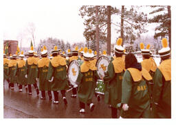 Marching Band Wearing Raincoats Walking down Road (Part of the NMU Historic Photographs Collection)