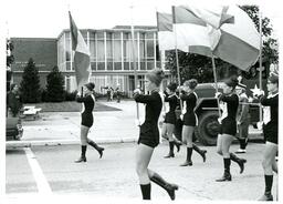 Flag Twirlers Marching in front of University Center (Part of the NMU Historic Photographs Collection)