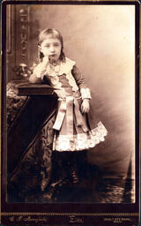 Young Girl Leaning on Table