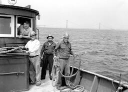 Boat in front of Mackinac Bridge