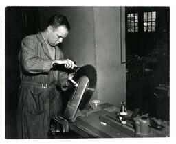 Student Using Tool to Sharpen Circular Saw Blade (Part of the NMU Historic Photographs Collection)