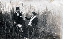 Couple Sitting Outside on Log