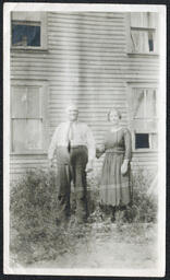 Two People Outside House