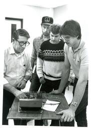 Professor and Students Gathered around Electronics (Part of the NMU Historic Photographs Collection)