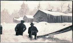 Two Men in Front of Long Buildings