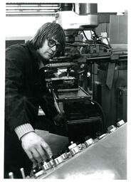 Student Twisting Knobs on Machinery (Part of the NMU Historic Photographs Collection)