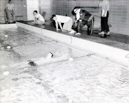 Swimming Team: Swimmer Does Backstroke to Finish