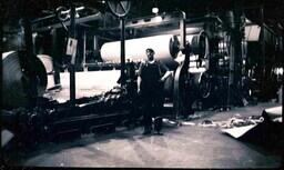 (010-007) Man Posing with Paper Mill Machine