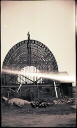 (008-021) Man Standing on Roof of Unfinished Building