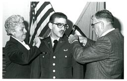 Parents Pinning Shoulders of Gibson (Part of the NMU Historic Photographs Collection)