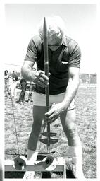 Man Prepares Model Rocket for Launch (Part of the NMU Historic Photographs Collection)