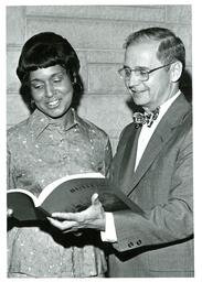 John X. Jamrich and Woman Looking at Northern Michigan University Bulletin (Part of the NMU Historic Photographs Collection)