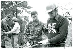 Captain John M., Sergeant Brian, Sten, and Jaube Rappelling in Woods (Part of the NMU Historic Photographs Collection)