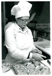 Culinary Student Placing Meat in Tray (Part of the NMU Historic Photographs Collection)