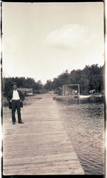 Man Smoking on Plank Bridge