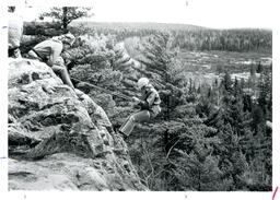 Person Rappelling Down Cliff while Two Others Watch (Part of the NMU Historic Photographs Collection)