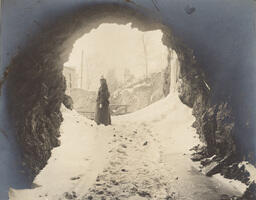 Mine entrance in winter with woman