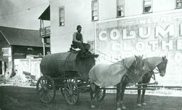 John Rule driving the sprinkling wagon over the streets of Iron Mountain