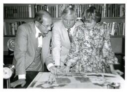 John X. Jamrich and Two Unknown People Looking at Drawings (Part of the NMU Historic Photographs Collection)