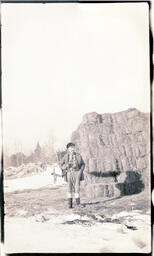 Man and Cat in Front of Hay