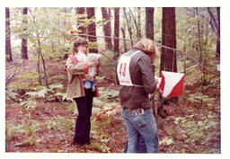 Two Competitors Writing on Papers in the Woods (Part of the NMU Historic Photographs Collection)