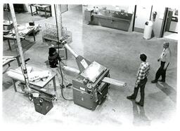 Overhead Shot of Student Feeding Board through Belt Sander (Part of the NMU Historic Photographs Collection)