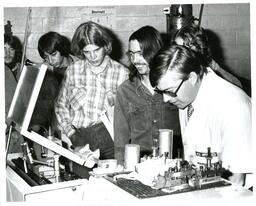 Students and Professor Examining Machinery (Part of the NMU Historic Photographs Collection)