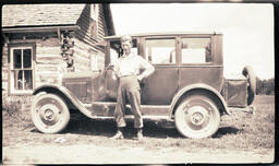 Young Man with Hammer in Front of Car