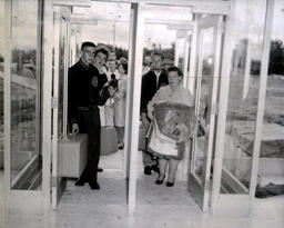 Beginning of Fall Semester 1960: People With Bags Walking In Doorway