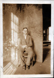 Boy with Glasses in Front of Photo Backdrop