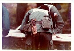 Closeup of Man in Military Uniform Leaning Down to Write Something (Part of the NMU Historic Photographs Collection)