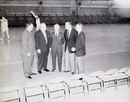 NMC - MSU Basketball Coaches and Officials February 4, 1961: Five Men in Suits on Side of Basketball Court