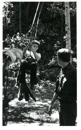 Child Riding Zipline in Woods (Part of the NMU Historic Photographs Collection)