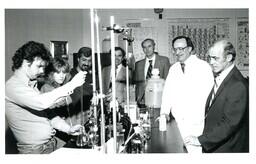 Group of People Watching Student Fill Beaker with Pipette (Part of the NMU Historic Photographs Collection)