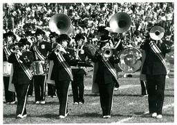 Brass and Percussion Sections of Marching Band Playing at Football Game (Part of the NMU Historic Photographs Collection)