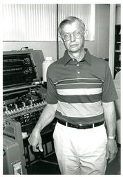 Man Standing next to Equipment (Part of the NMU Historic Photographs Collection)