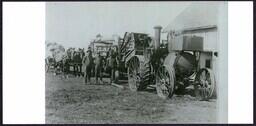 John and Charles Swanson and Unidentified Man on Threshing Crew