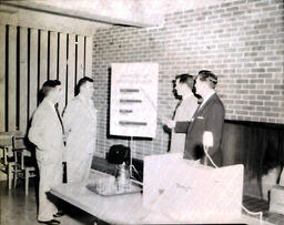 Jon (?) Railroad Trainer--Jack Myers Dec. 1960:  Four Men Looking at Presentation Board