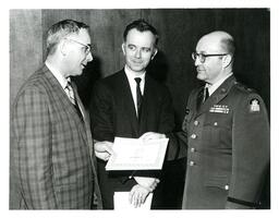 Three Men Talking and Holding Awards (Part of the NMU Historic Photographs Collection)