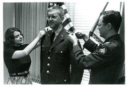 Two People Pinning the Shoulders of Man in Military Uniform (Part of the NMU Historic Photographs Collection)